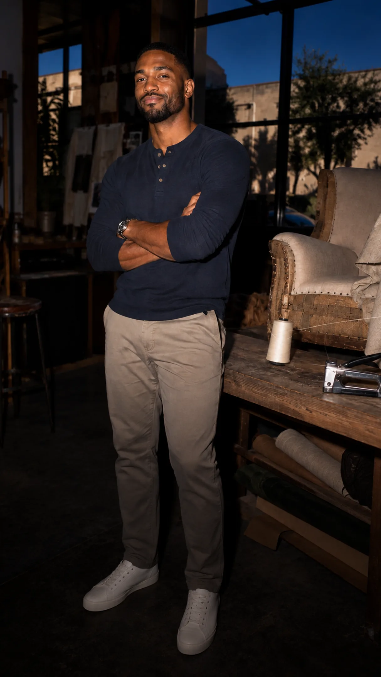 An operator at an upholstery workshop window, arms folded — the messaging checks every Page reply passes.